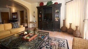 A living room with a sofa, coffee table, and decorative vases.