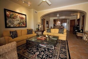 Relax in this stylish living area with a comfortable sofa, coffee table, and contemporary artwork.