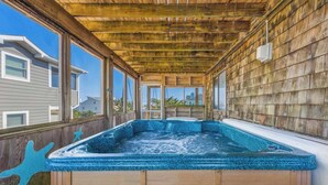 A hot tub with a wooden deck and a view of houses. - Oceanview Dog Friendly w/ Hot Tub, Games, Community Pool and Tennis/Pickleball (Avon)
