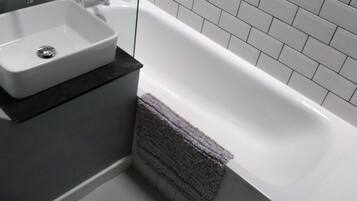 Combined shower/bathtub, hair dryer, towels, soap