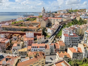 A cityscape with historic buildings, a prominent dome, and a waterfront.