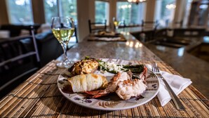A dining table with a plate of lobster, asparagus, and a glass of white wine. - S. Tahoe Luxury Home, 5 Minutes to Heavenly lodge (South Lake Tahoe)