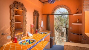 A bathroom with a tiled sink, two mirrors, a towel rack, and a view of the outside. - Lux in Yelapa, Infinity Pool, Huge Views, AC, Accommodates 8 to 10 (Yelapa)