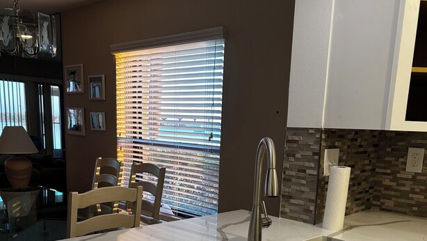 A modern kitchen with a white marble countertop, a double sink, and a built-in dishwasher. - 1 month minimum, waterfront, see dolphins, pool/hot tub (Saint Petersburg)