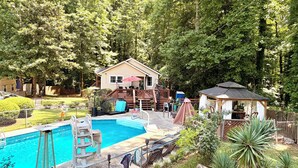 A backyard with a swimming pool, a deck, a small gazebo, and a house. - Atlanta Pool Home Near Airport, Near Airport 8 guests Max (Atlanta)