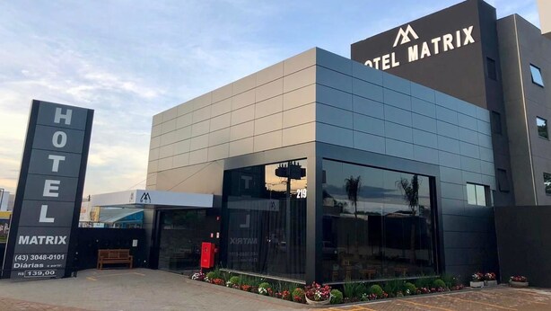 Um hotel moderno com uma placa de destaque que diz 'HOTEL MATRIX'.
