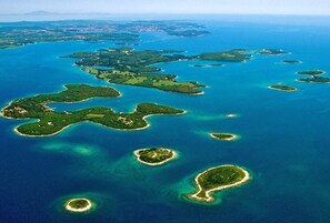An aerial view of a coastal area with multiple small islands and clear blue waters. - large villa with pool and spa (Pomer)