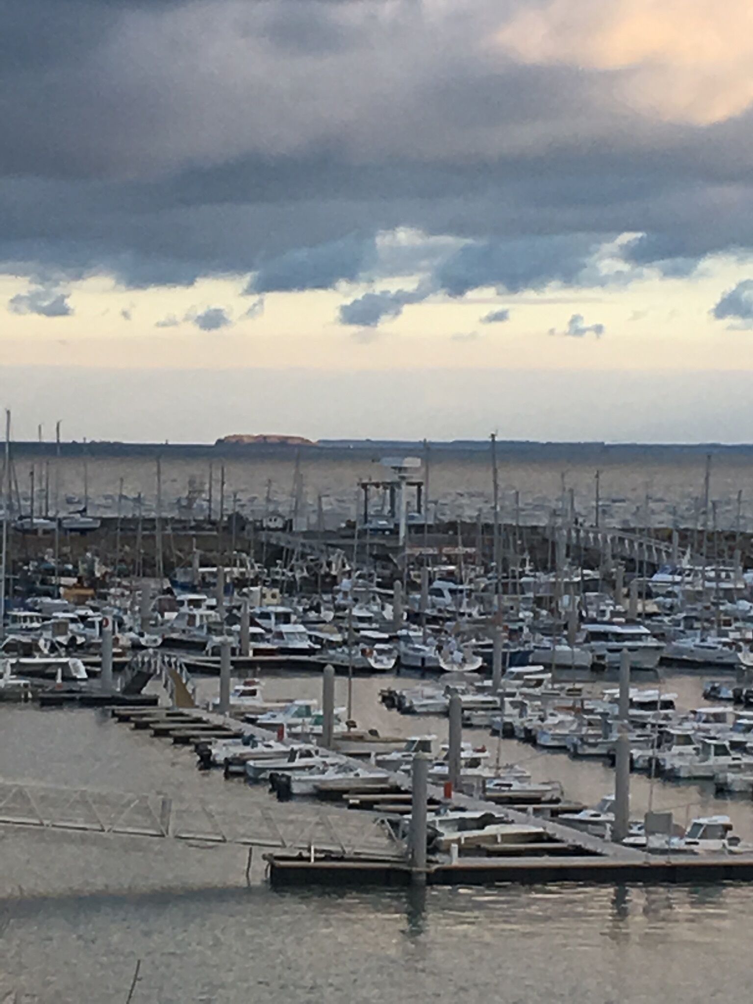 A marina with numerous boats docked at piers.