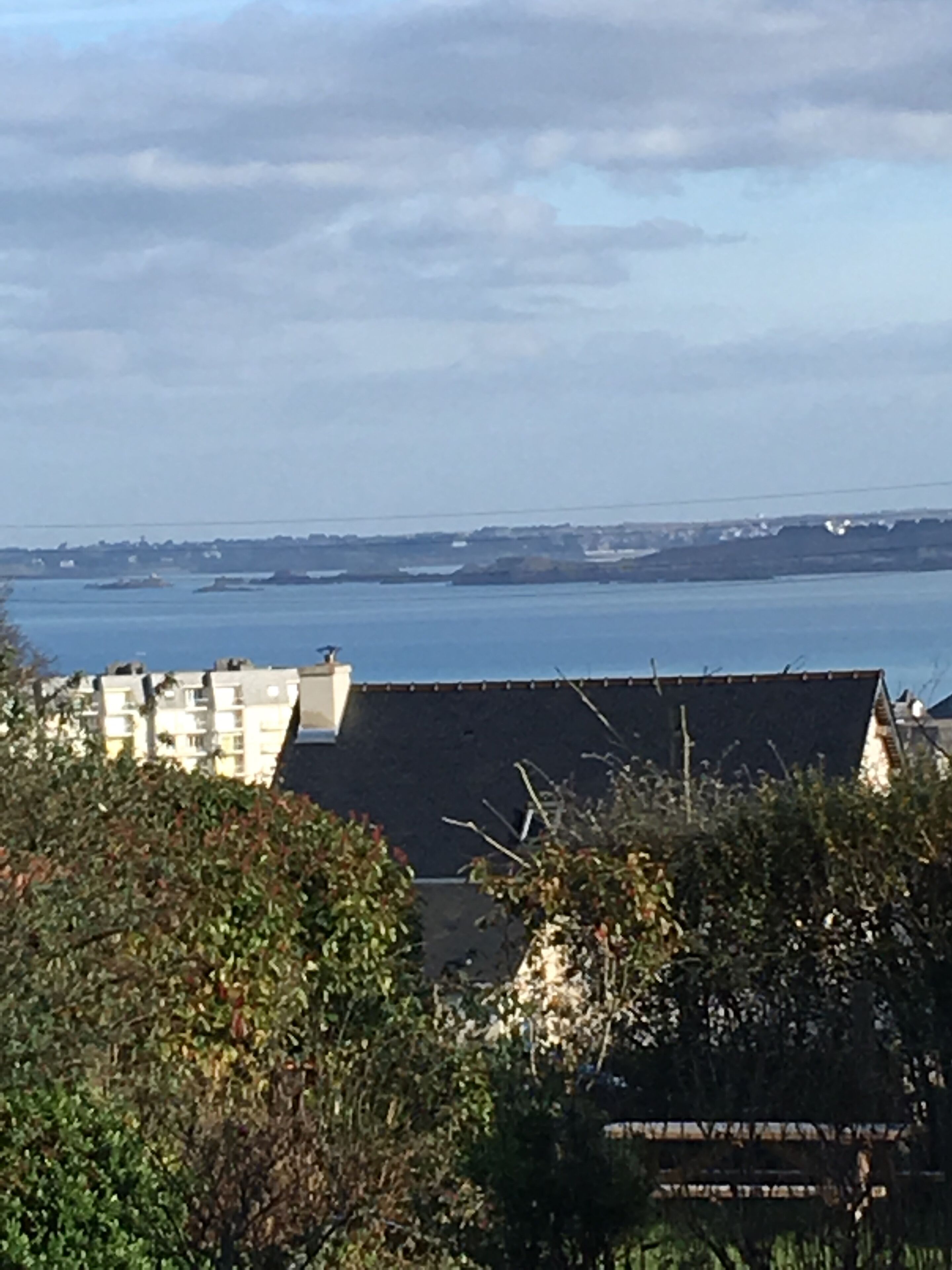 A coastal view with buildings and a body of water.