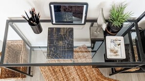 A glass-top table with a black notebook, a tablet, and a plant. - Put some MAGIC into your vacation.  Disney only 20 minutes away! (Haines City)