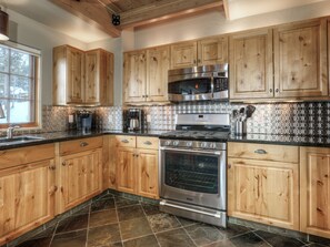 Enjoy cooking in this well-equipped kitchen with a double oven, microwave, and coffee maker.