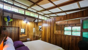A wooden room with a bed, a desk, and a window. - Cozy Caribbean Beachfront House (Pet & Kid Friendly) (Puerto Viejo)