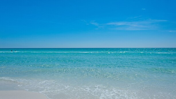 A beach with clear turquoise water and white sand. - Great beach house with access to pools and restaurants.
 (Miramar Beach)