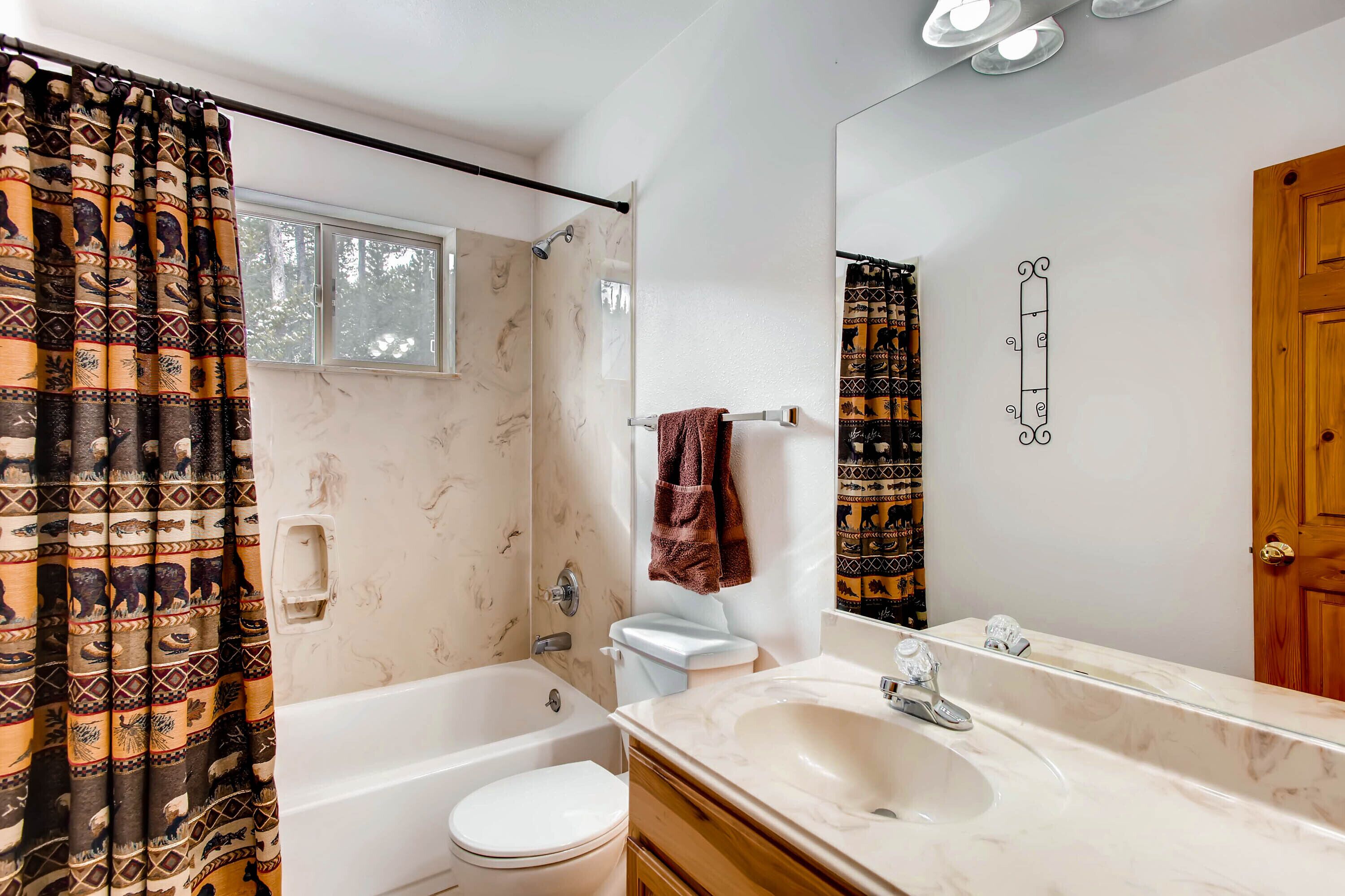 A bathroom with a bathtub, toilet, and sink.