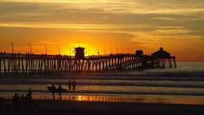 A pier extending into the water with a sunset in the background. - Spacious ocean View Penthouse sleeps 8-10 w/large ocean facing deck! (Imperial Beach)