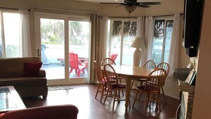A spacious room with a dining table and chairs, a sofa, and a ceiling fan. - Spacious ocean View Penthouse sleeps 8-10 w/large ocean facing deck! (Imperial Beach)