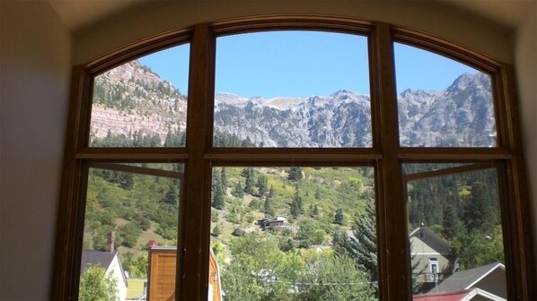 Enjoy breathtaking views of the surrounding mountains and valley from this room's expansive window.