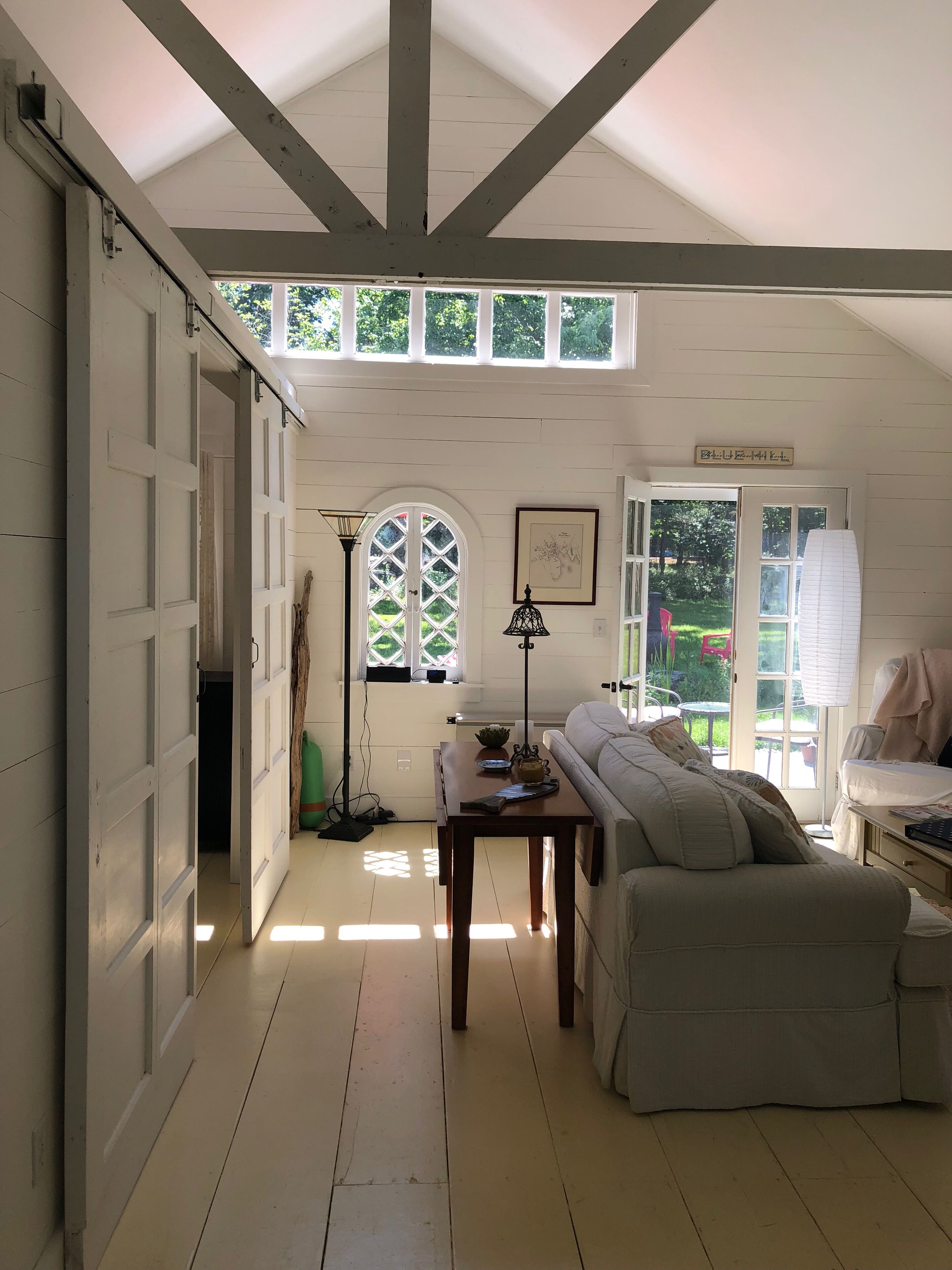 Bedroom is divided by sliding barn doors 