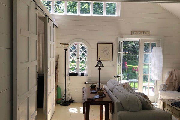Bedroom is divided by sliding barn doors