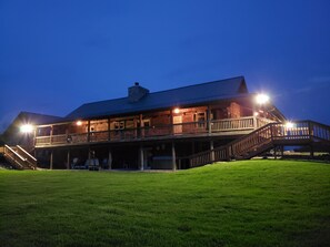 A two-story wooden building with a balcony and a staircase leading to the upper level.