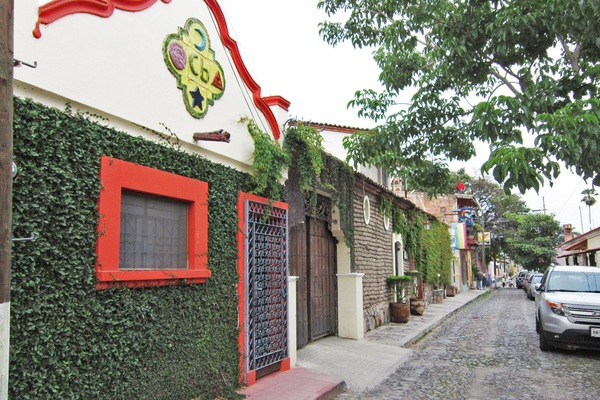 Cobblestone Calle Independencia and adobe home next door to Casa Barbara.
