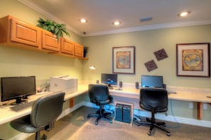 A home office with two desks, two chairs, a printer, two monitors, and a plant. - Beach Club 207, Oceanfront complex (St Simons Island)