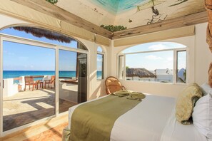 A bedroom with a large bed, a view of the ocean, and a balcony with outdoor seating. - Secluded Beach Front Boutique Resort with 6 Villas, each with Private Pools! (Playa del Carmen)