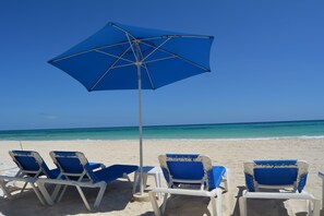 On the beach, sun loungers, beach towels