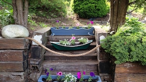 A wooden staircase with flower planters on each step.
