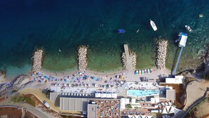 An aerial view of a beach resort with a swimming pool, sun loungers, and boats in the water. - Villa 5 stars , Istra , Croatia (Sveta Nedelja, Istarska županija)