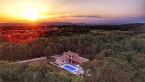 A villa with a swimming pool, surrounded by forested hills, during sunset. - Villa 5 stars , Istra , Croatia (Sveta Nedelja, Istarska županija)