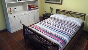 A bedroom with a bed, a wardrobe, and a nightstand. - Spacious in-suite room Bo. Herrera, Asuncion (Asunción)