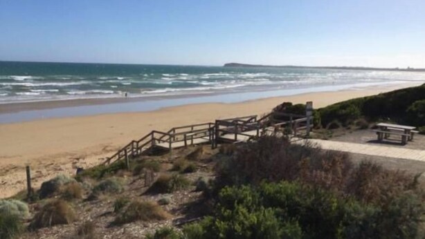A beach with a wooden walkway leading to a bench area. - Dare St Beach Apartment | 2-Min Walk to Beach & Town (Ocean Grove)