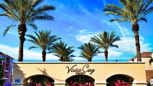 Vista Cay Resort with palm trees and a clear sky.