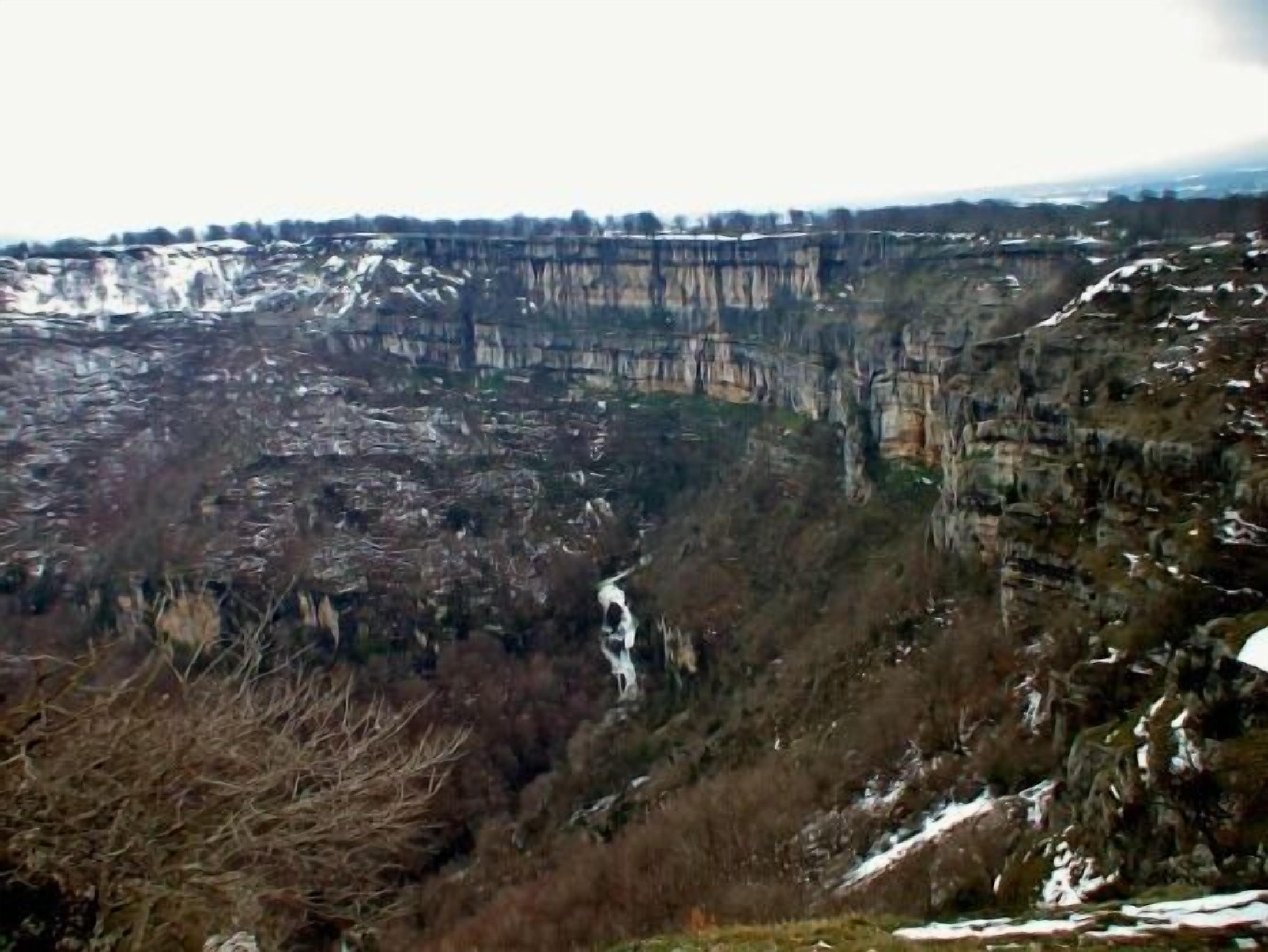A mountainous landscape with a river flowing through a valley.