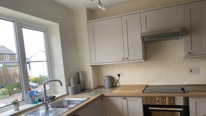Una cucina moderna dotata di lavastoviglie, forno e una finestra con vista all'esterno.