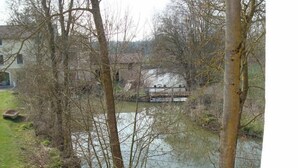 Une rivière avec un pont et des bâtiments en arrière-plan.