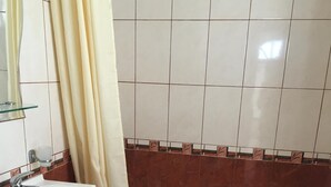 A bathroom with a white sink, a bathtub, and a shower curtain. - 5 Star Luxury Villa - Large Private Pool - Spacious Rooms - Panoramic Sea Views (Balchik/Albena, Black Sea Coast)