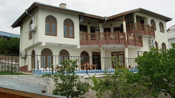 A two-story house with a balcony, a swimming pool, and a fenced yard. - 5 Star Luxury Villa - Large Private Pool - Spacious Rooms - Panoramic Sea Views (Balchik/Albena, Black Sea Coast)