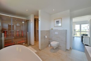 Bathtub, hair dryer, toilet paper
