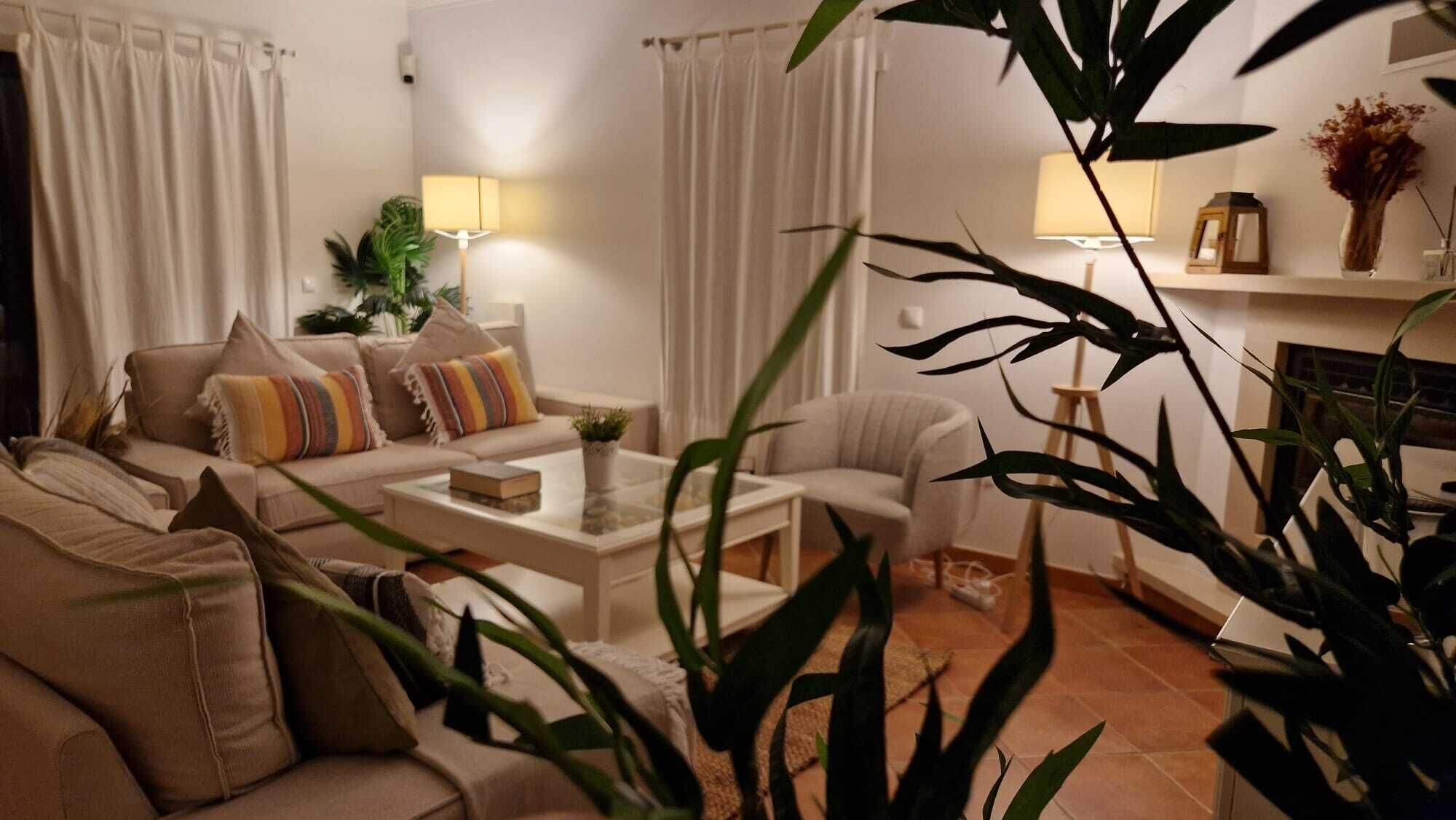 A living room with a sofa set, a coffee table, and a fireplace.
