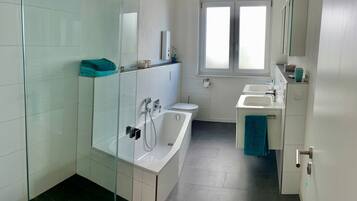 Bathtub, hair dryer, towels, soap
