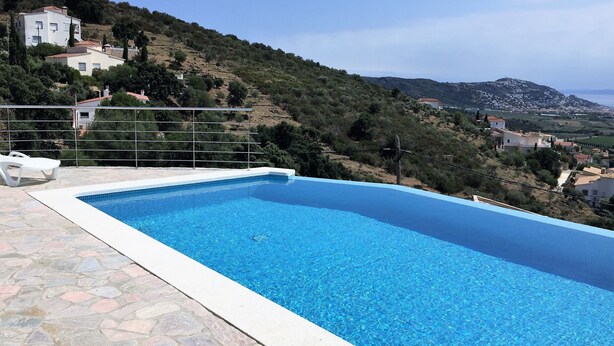A rectangular swimming pool with a tiled edge, surrounded by stone tiles. - CASA MIREILLA - Apartment with perfect sea view & private pool (El Mas Fumats)