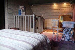 A bedroom with a bed, a chair, a dresser, and a mirror. - Gites NORMANDY near Honfleur with Pool and Sauna (Fatouville-Grestain)