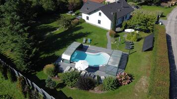 A heated pool, pool loungers