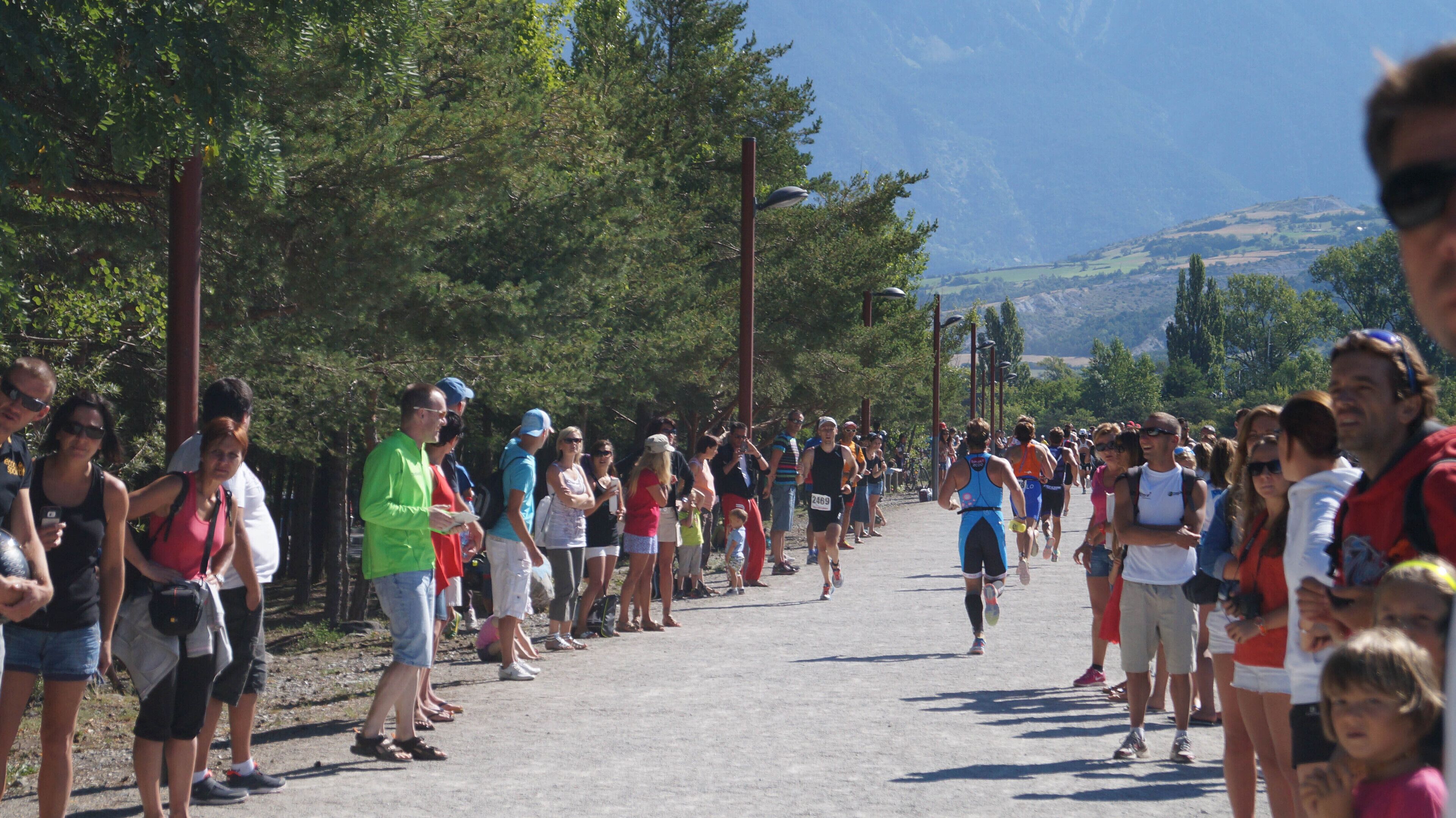 A group of people participating in a marathon event, with spectators lining the route.
