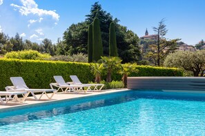 Outdoor pool, a heated pool, sun loungers