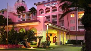A pink hotel with a dome and arched windows, named Palm Beach Shores. - Palm Beach Shores Ocean Front Resort, Singer Island One Bedroom ~ Valet Parking (Palm Beach Shores)