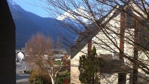 Un quartier résidentiel avec des maisons, une route et une montagne en arrière-plan.