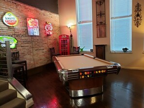 Enjoy a game of pool in our billiards room, featuring a classic pool table and unique decor.